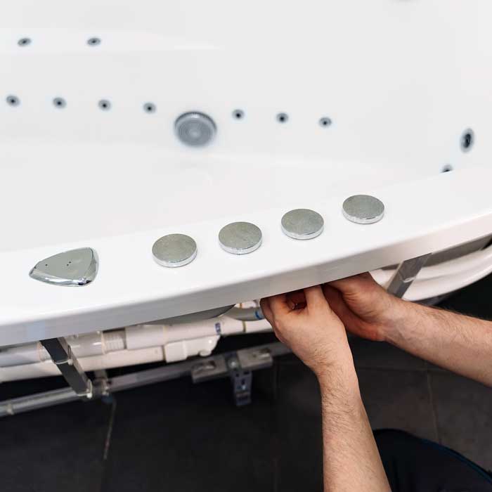 A professional fixes a hot tub leak